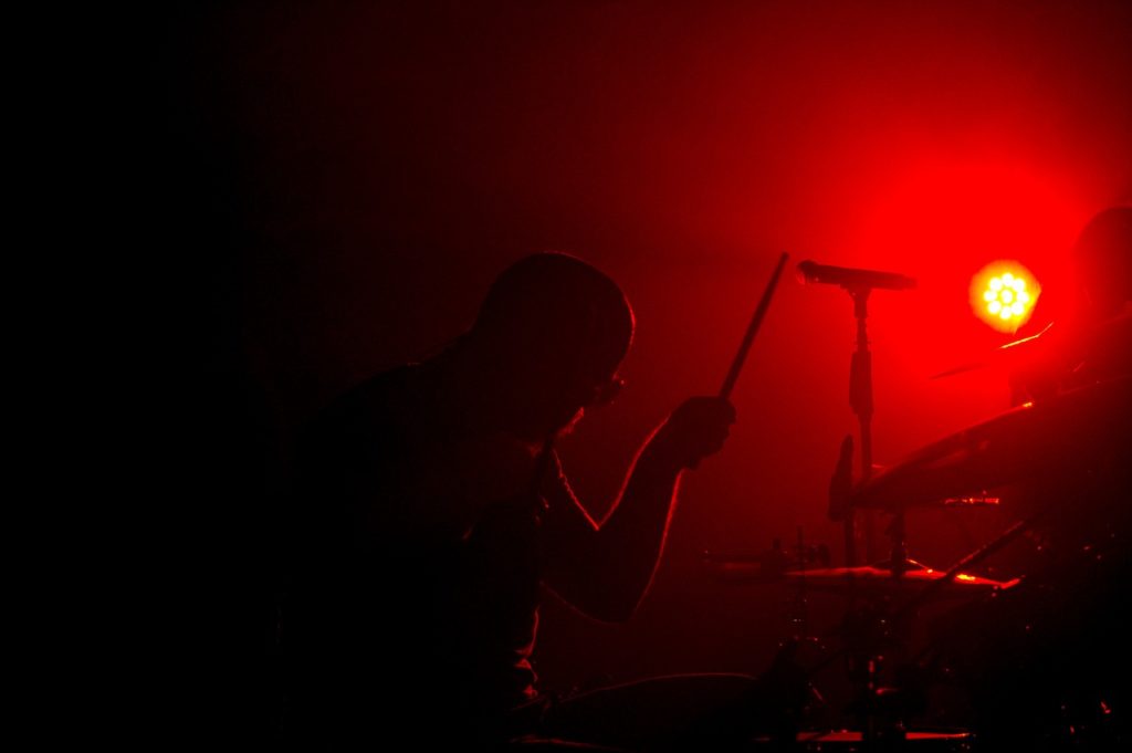 Why Do Drummers Have Glass Screens Around Them?