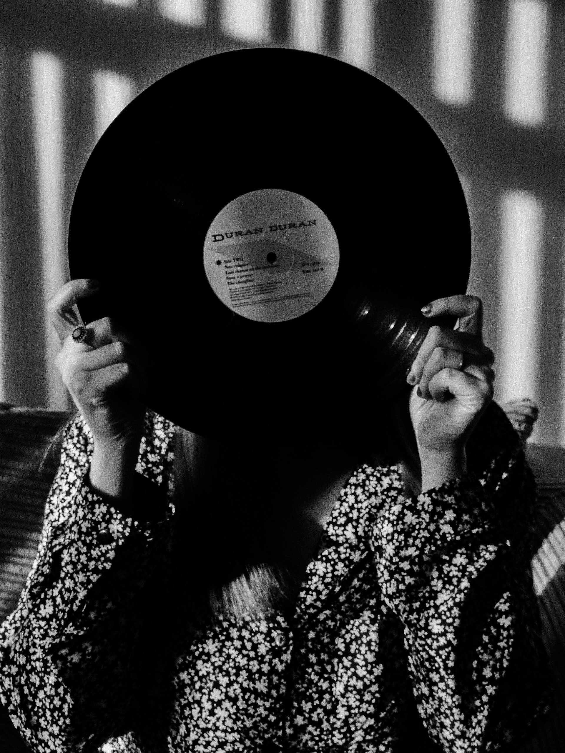 Woman holding a Duran Duran record