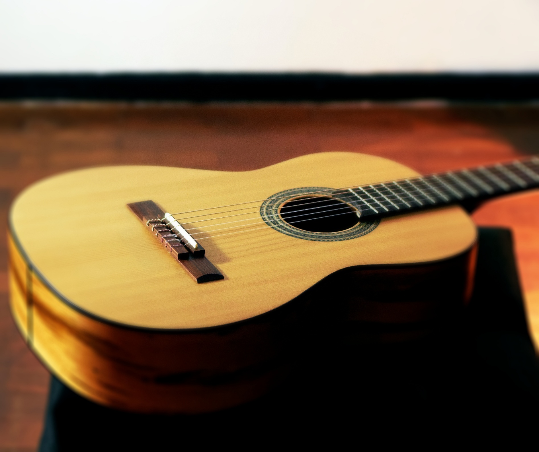 Classical acoustic guitar sitting flat