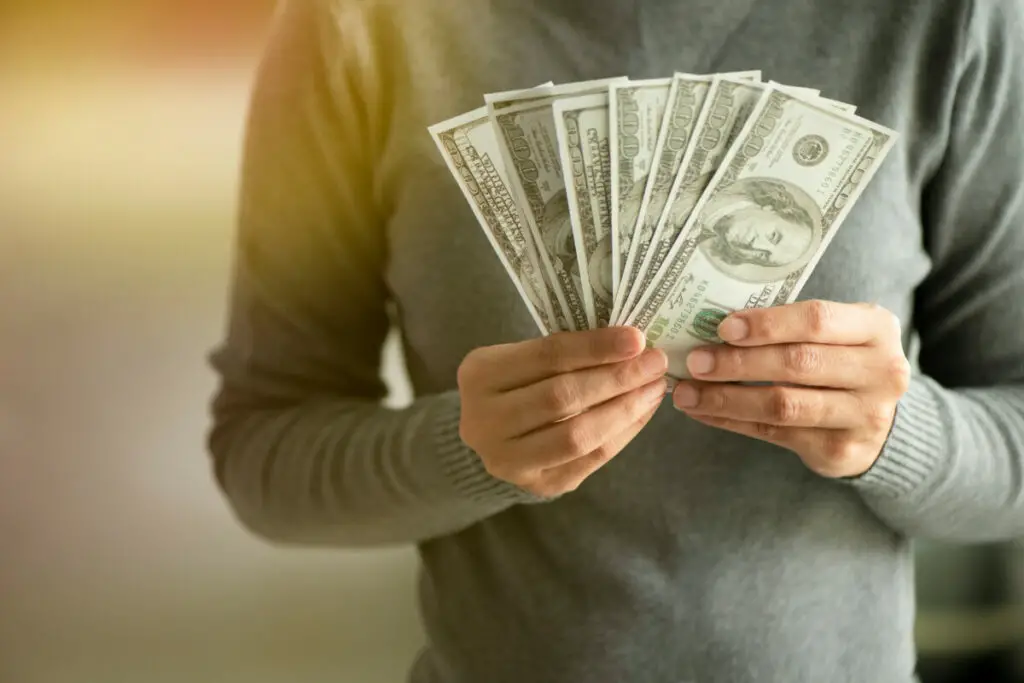 How Does SoundCloud Make Money - intro image- man wearing suit holding money