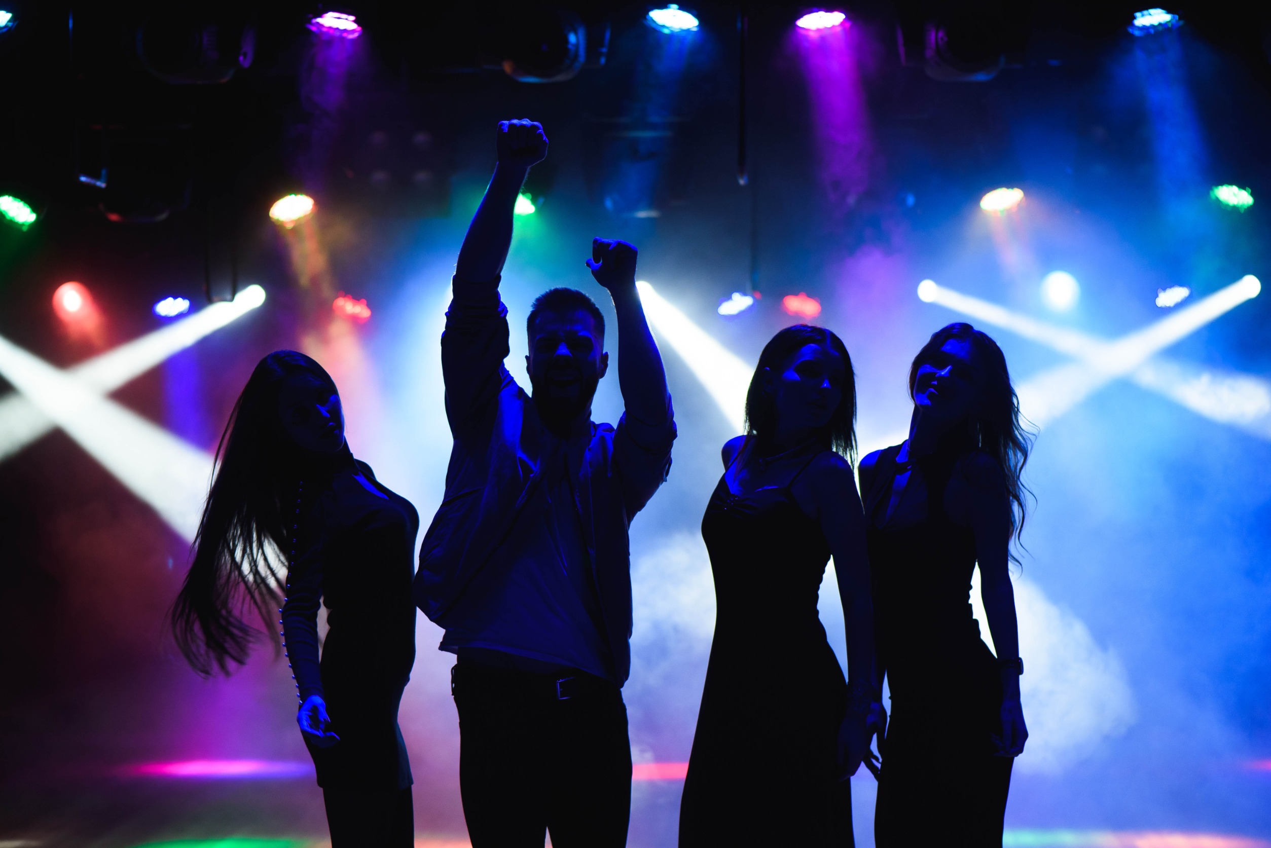 What is a VIP Remix in EDM? - blog intro image - group of four at an EDM show with lights